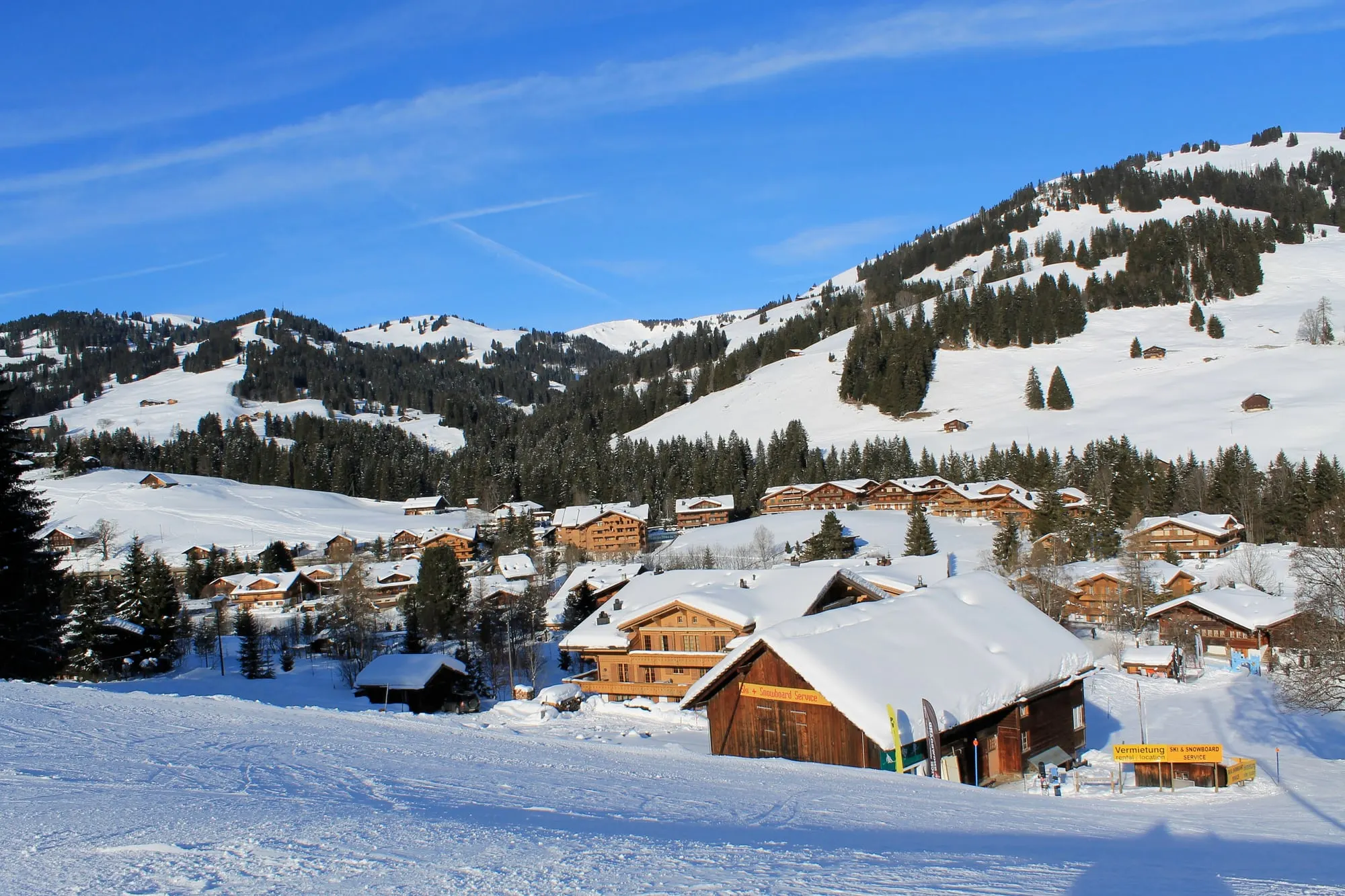 Saanenmöser chalets below snowy ski slopes